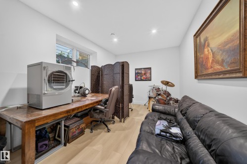 Recessed lighting, wood-finish flooring, white walls, and a wood-finish desk - 17128 2 Street Nw, Edmonton, AB 