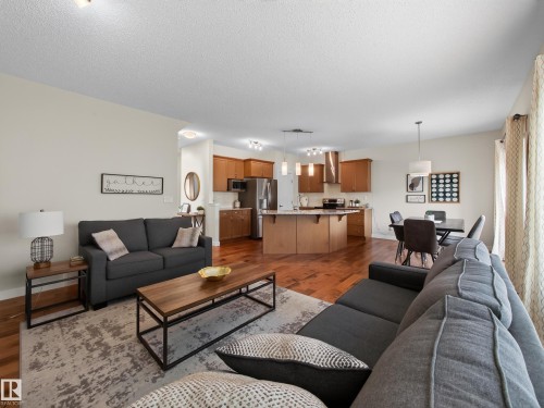 Open concept living space featuring wood-finish flooring throughout - 6504 48 Avenue, Beaumont, AB - Indoor Photo Showing Living Room