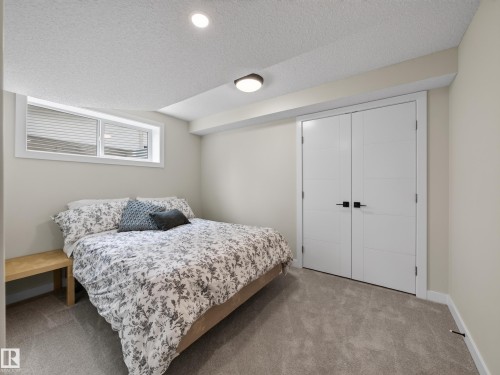 Neutral tone wall paint, recessed lighting, and a flush mount light fixture illuminate this room - 6504 48 Avenue, Beaumont, AB - Indoor Photo Showing Bedroom
