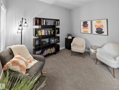 Neutral gray walls complement the textured gray carpet - 6504 48 Avenue, Beaumont, AB - Indoor