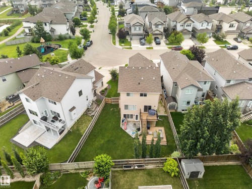 Expansive fenced backyard featuring a multi-level deck, a lower patio area, and a storage shed - 6504 48 Avenue, Beaumont, AB - Outdoor With View