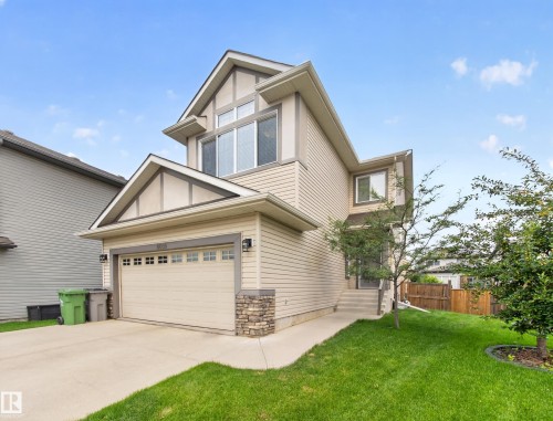 Contemporary two-story home featuring light-colored siding and a prominent front-facing gable - 6504 48 Avenue, Beaumont, AB - Outdoor
