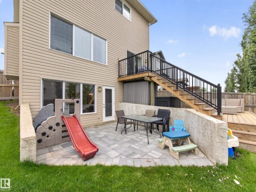 Two-tier outdoor living space featuring a paver patio and a multi-level wood deck - 6504 48 Avenue, Beaumont, AB - Outdoor With Deck Patio Veranda With Exterior