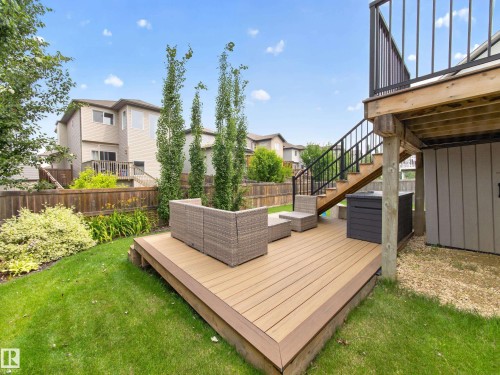 Multi-level outdoor deck featuring composite wood-finish decking and black metal railings - 6504 48 Avenue, Beaumont, AB - Outdoor With Exterior