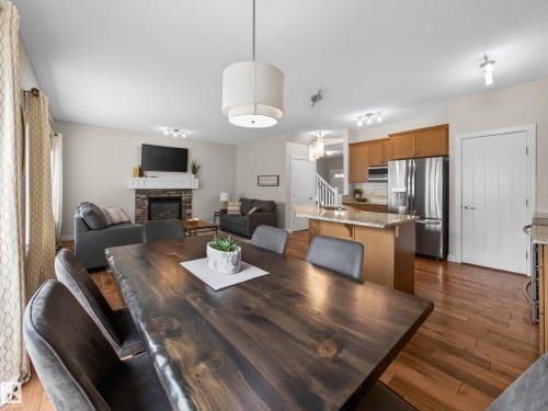 Open-concept living area featuring wood-finish flooring throughout - 6504 48 Avenue, Beaumont, AB - Indoor