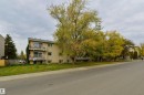 Three-story building with multiple balconies and a beige exterior - #205 10140 151 St Nw, Edmonton, AB  - Outdoor With Balcony 