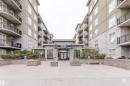 Contemporary building facade featuring a prominent entrance, stone accents, and multiple balconies - #1-405 4245 139 Av Nw, Edmonton, AB 