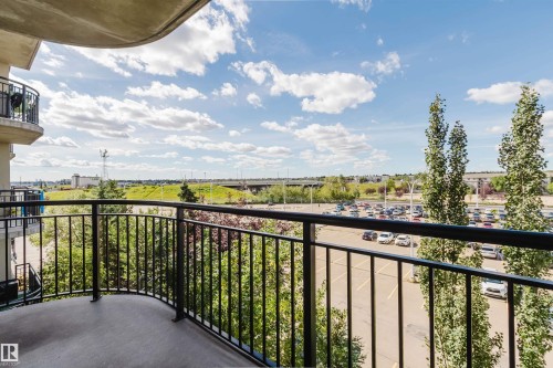 Private balcony with black metal railings and concrete flooring - #1-405 4245 139 Av Nw, Edmonton, AB 