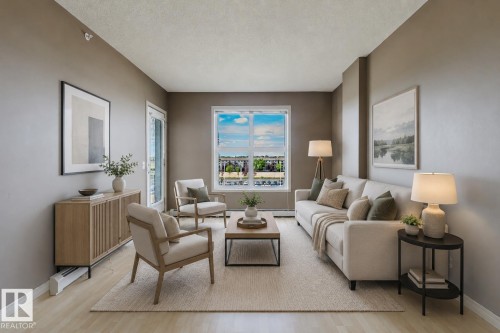 Wood-finish flooring throughout, complemented by a large window and glass-paned door - #1-405 4245 139 Av Nw, Edmonton, AB 