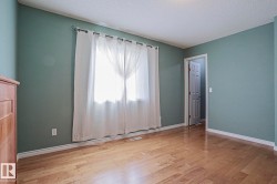 Wood-finish flooring with light wall paint and white trim - 