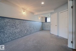 Recessed lighting and wall-mounted fixtures illuminate the space - 