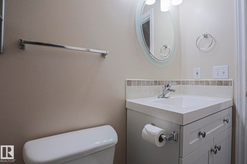 Vanity with integrated sink, chrome faucet, and white cabinetry - 15031 135 Street Nw, Edmonton, AB 