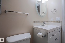 Vanity with integrated sink, chrome faucet, and white cabinetry - 