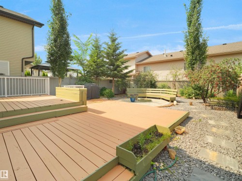 Multi-level wood deck with built-in planters and white railing - 2410 32B Street Nw, Edmonton, AB 