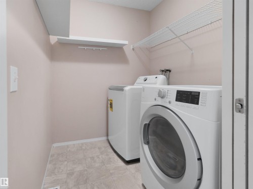 Laundry area with tiled flooring, neutral wall paint, and wire shelving - 2410 32B Street Nw, Edmonton, AB 