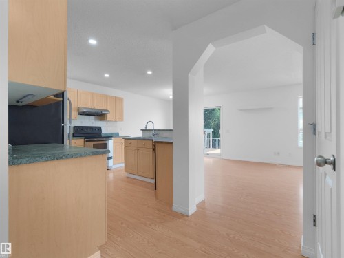 Kitchen featuring wood-finish cabinetry, stainless steel appliances, and recessed lighting - 2410 32B Street Nw, Edmonton, AB 