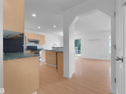 Kitchen featuring wood-finish cabinetry, stainless steel appliances, and recessed lighting - 