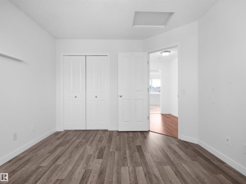 Wood-finish flooring, white walls, and a ceiling-mounted light fixture - 2410 32B Street Nw, Edmonton, AB 