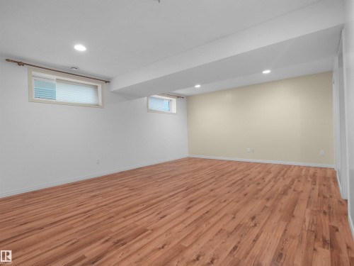 Wood-finish flooring, recessed lighting, and multiple windows - 2410 32B Street Nw, Edmonton, AB 