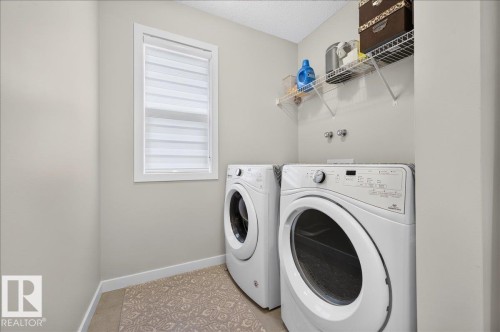 Functional utility space with neutral wall tones and a window with blinds - 2709 Collins Crescent Sw Sw, Edmonton, AB - Indoor Photo Showing Laundry Room