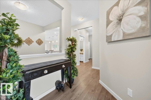 Entryway featuring wood-finish flooring, neutral wall paint, and white trim - 2709 Collins Crescent Sw Sw, Edmonton, AB - Indoor Photo Showing Other Room