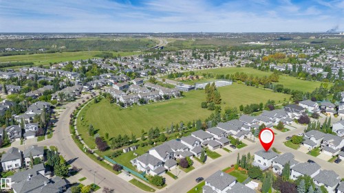 Aerial perspective of a residential community featuring extensive green spaces and mature landscaping - 2407 Hagen Way Nw, Edmonton, AB 