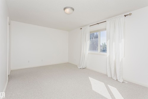 Recessed window, ceiling-mounted light fixture, and light-colored carpeting - 2407 Hagen Way Nw, Edmonton, AB 
