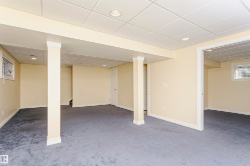 Expansive finished space featuring recessed lighting, light-toned walls, and a dropped ceiling with grid panels - 2407 Hagen Way Nw, Edmonton, AB 