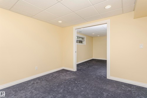 Recessed lighting, drop panel ceiling, neutral wall paint, white trim, and carpeting - 2407 Hagen Way Nw, Edmonton, AB 
