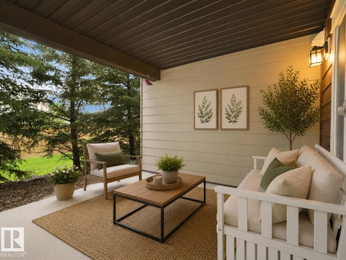 Covered patio with a paneled ceiling, exterior wall lighting, and horizontal siding - #114 12035 22 Av Sw, Edmonton, AB 
