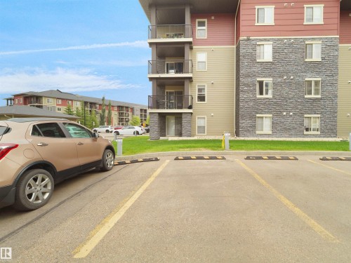 Paved parking area featuring striped parking spaces - #114 12035 22 Av Sw, Edmonton, AB 