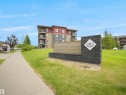 Modern multi-story building with a flat roofline and private balconies - #114 12035 22 Av Sw, Edmonton, AB 