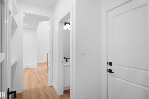 Hallway featuring wood-finish flooring and recessed lighting - 142 Edgewater Circle, Leduc, AB 