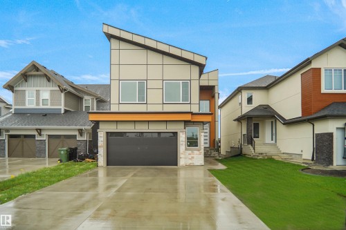 Modern architectural exterior featuring a prominent angled roofline - 142 Edgewater Circle, Leduc, AB 