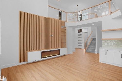 Open-concept living space with light wood-finish flooring - 142 Edgewater Circle, Leduc, AB 