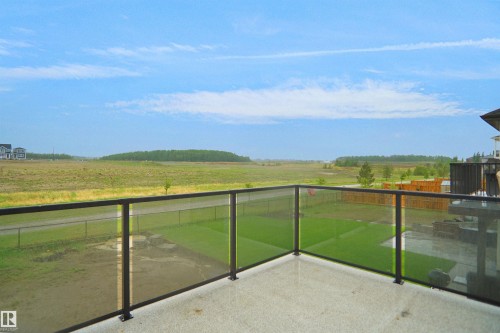 Outdoor patio with glass railing and black metal posts - 142 Edgewater Circle, Leduc, AB 