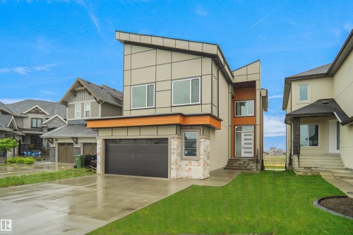 Contemporary exterior featuring a flat roofline and multi-toned facade - 142 Edgewater Circle, Leduc, AB 