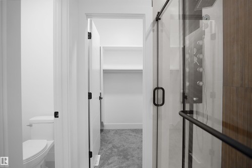 Walk-in shower with clear glass enclosure and black hardware - 142 Edgewater Circle, Leduc, AB 