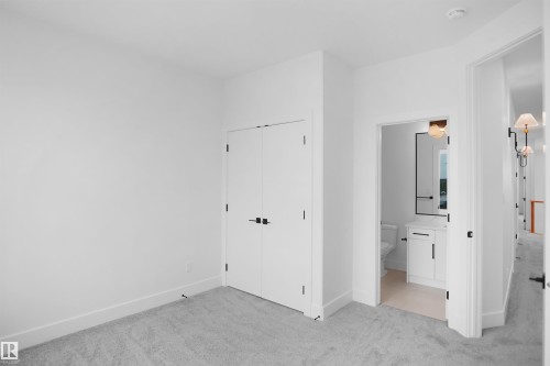 White walls and light gray carpeting establish a neutral palette - 142 Edgewater Circle, Leduc, AB 