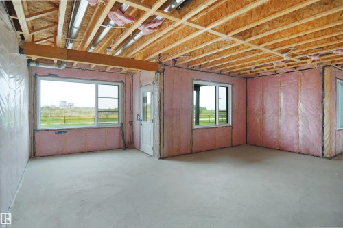 Unfinished lower level featuring exposed wood joists and subflooring, insulated walls, and a concrete floor - 142 Edgewater Circle, Leduc, AB 
