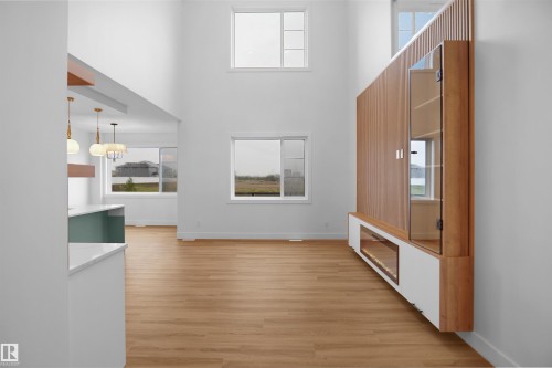 Soaring ceilings and light wood-finish flooring define this open-concept space - 142 Edgewater Circle, Leduc, AB 