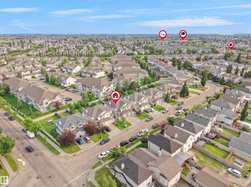 Residential neighborhood featuring detached and attached properties with private driveways and green spaces - 8111 7 Ave Avenue Sw, Edmonton, AB 