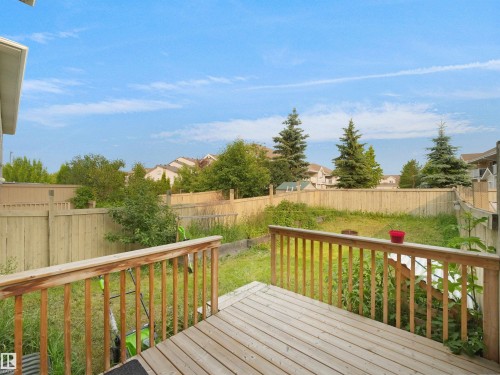 Rear wood deck with wood railing - 8111 7 Ave Avenue Sw, Edmonton, AB 