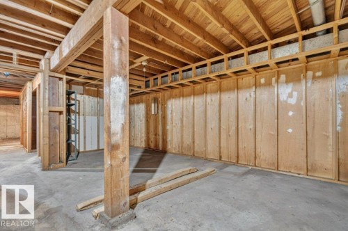 Unfinished basement featuring exposed wood ceiling joists and concrete flooring - 12705 87 Street Nw, Edmonton, AB 