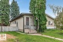 Stucco exterior with a gable roofline, concrete steps, and a wrought iron railing - 12705 87 Street Nw, Edmonton, AB 
