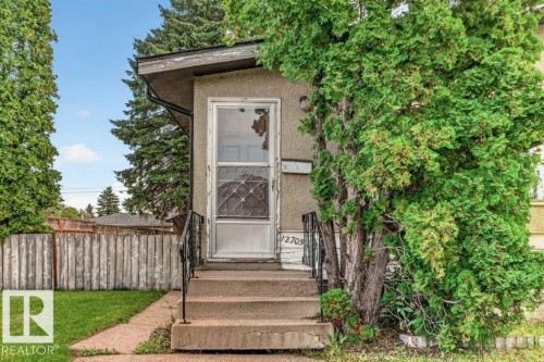 Front entry with concrete stairs, metal handrails, and a storm door - 12705 87 Street Nw, Edmonton, AB 