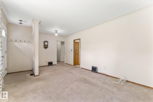 Carpeted flooring, neutral wall tones, recessed lighting, and a white entry door - 9315 86 Street Nw, Edmonton, AB 