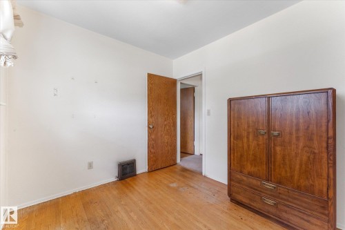 Hardwood flooring and a wood-finish door - 9315 86 Street Nw, Edmonton, AB 