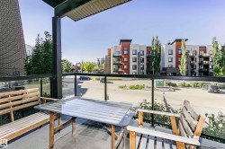 Covered balcony with glass panel railing and solid exterior wall - 