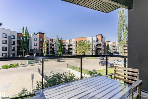 Balcony featuring glass railings and composite decking - #217 304 Ambleside Link Sw, Edmonton, AB 
